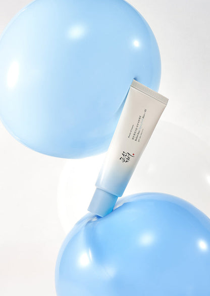 Tube of cream on a blue balloon with a white background