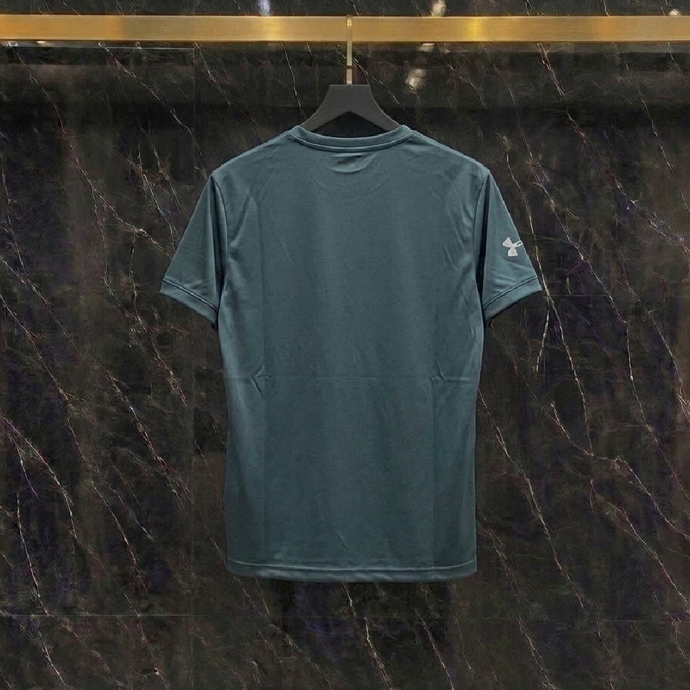 A dark teal short-sleeve t-shirt hanging on a black hanger against a dark marble wall with gold veining.