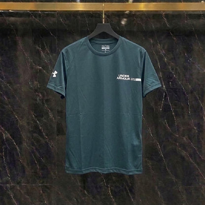 A dark teal Under Armour short-sleeve athletic t-shirt hanging on a black hanger against a dark marble-patterned wall.