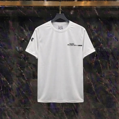 A white short-sleeve athletic t-shirt with black Under Armour logos, hanging on a black hanger against a dark, textured marble wall.
