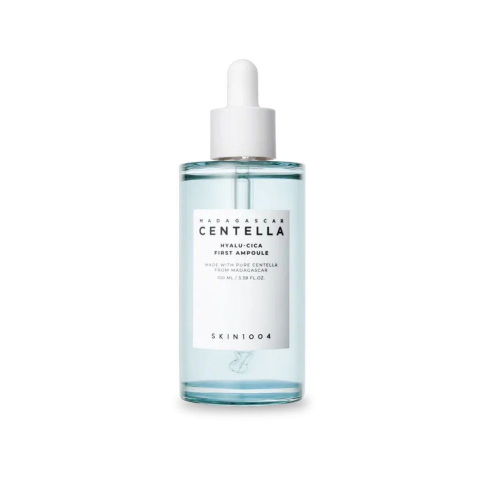 A clear glass dropper bottle of SKIN1004 Wildharvest Centella Hyalu-Cica First Ampoule, containing a pale blue liquid, with a white label and white dropper cap, set against a plain white background.