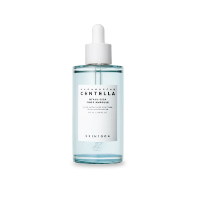 A clear glass dropper bottle of SKIN1004 Wildharvest Centella Hyalu-Cica First Ampoule, containing a pale blue liquid, with a white label and white dropper cap, set against a plain white background.