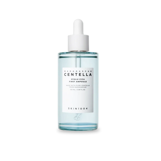A clear glass dropper bottle of SKIN1004 Wildharvest Centella Hyalu-Cica First Ampoule, containing a pale blue liquid, with a white label and white dropper cap, set against a plain white background.